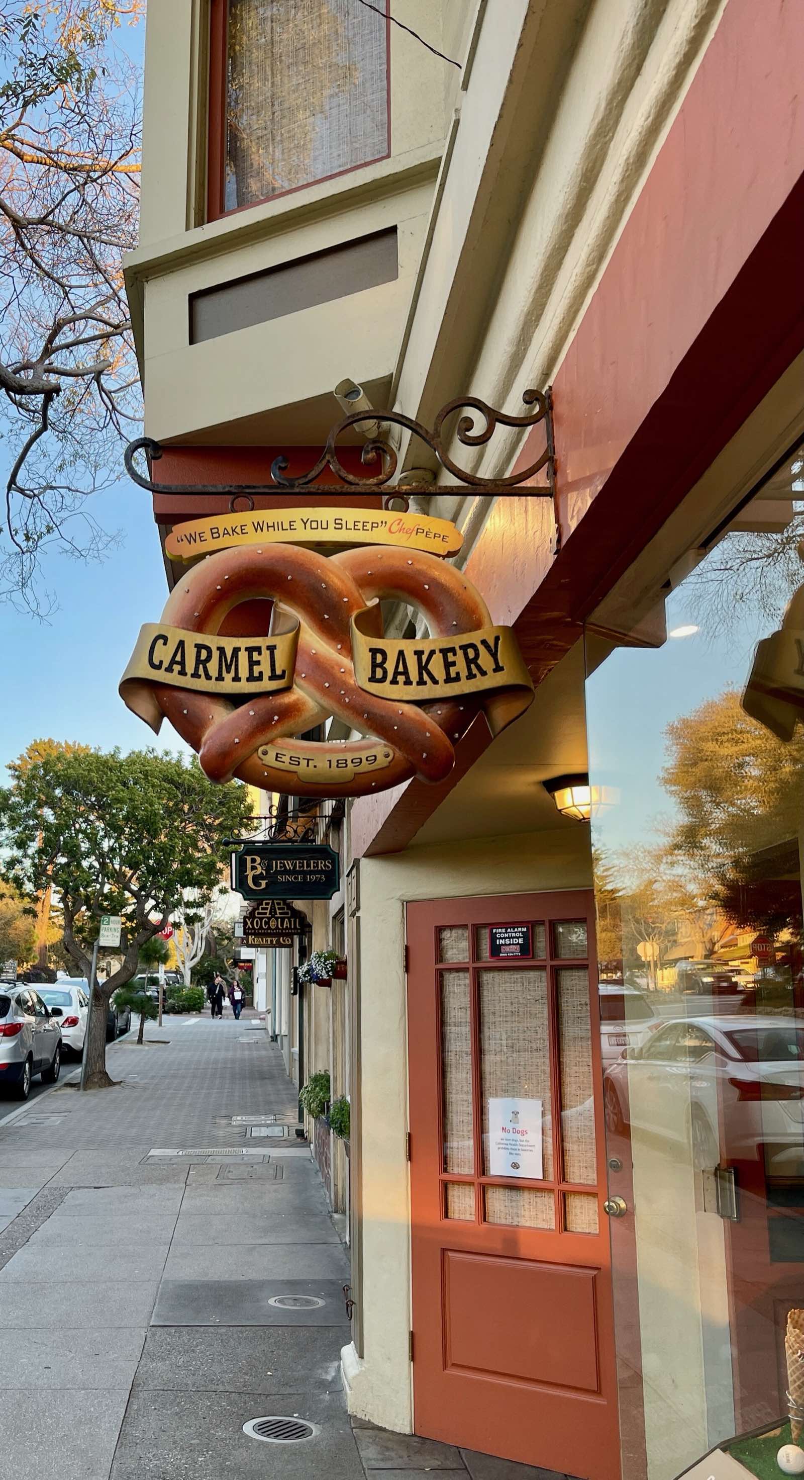 Vintage-style Carmel Bakery sign mounted on the historic bakery building.