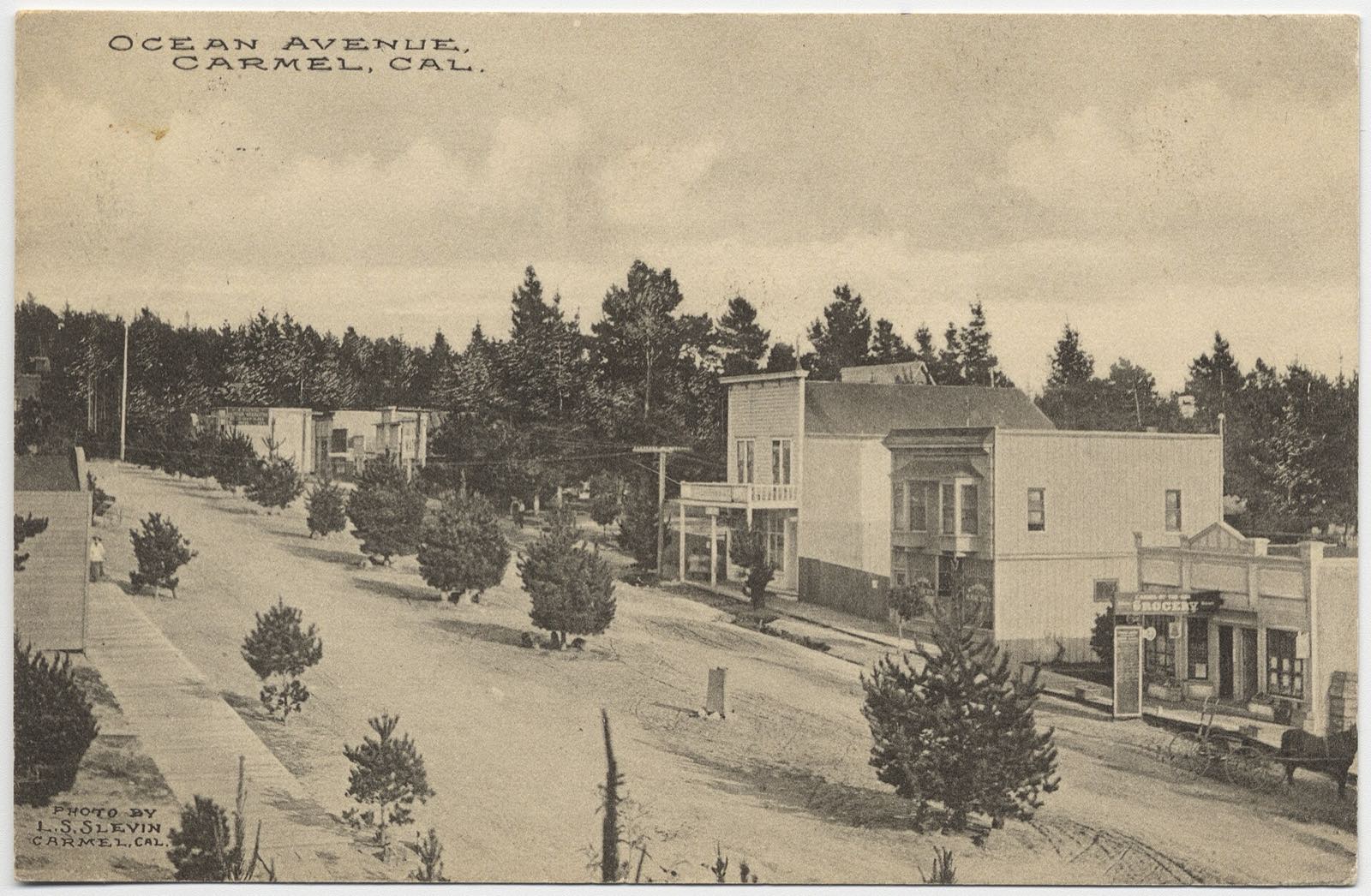 Historic view down Ocean Avenue with shops and trees in Carmel-by-the-Sea.